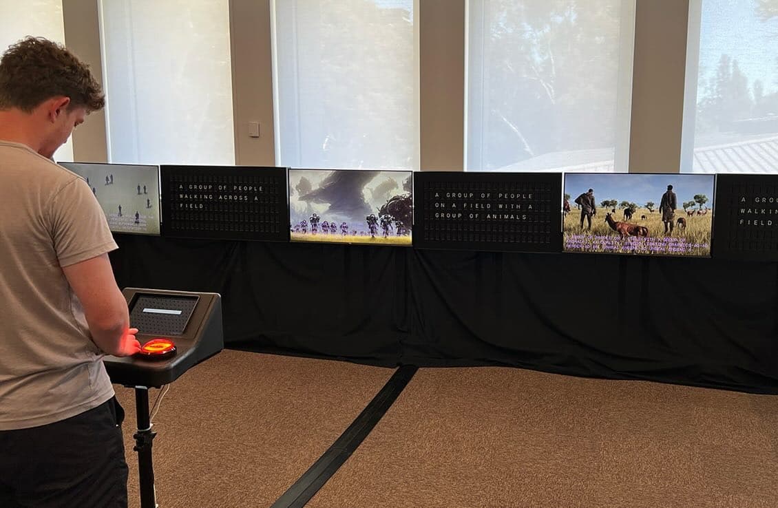 Someone standing at a black computer terminal, with multiple screens displaying the outputs of different AI models